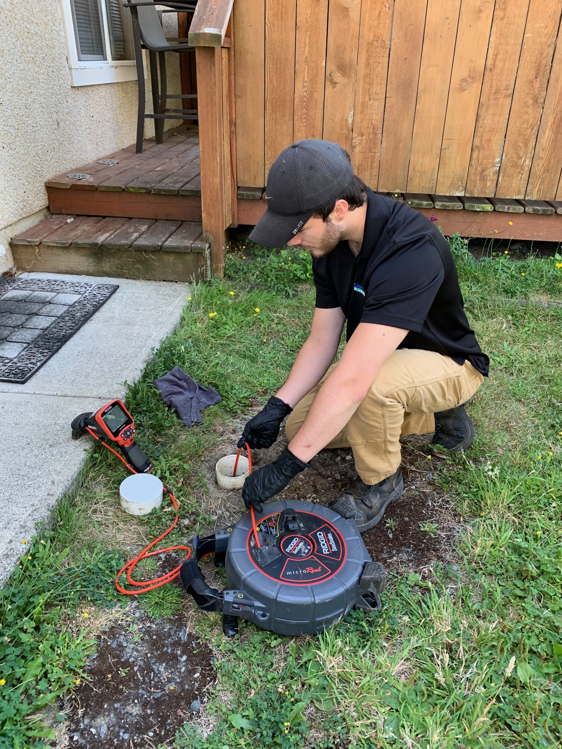 Victoria Plumber 4 A photo of a plumber working for the clear choice plumbing completing a camera inspection in a customer's yard